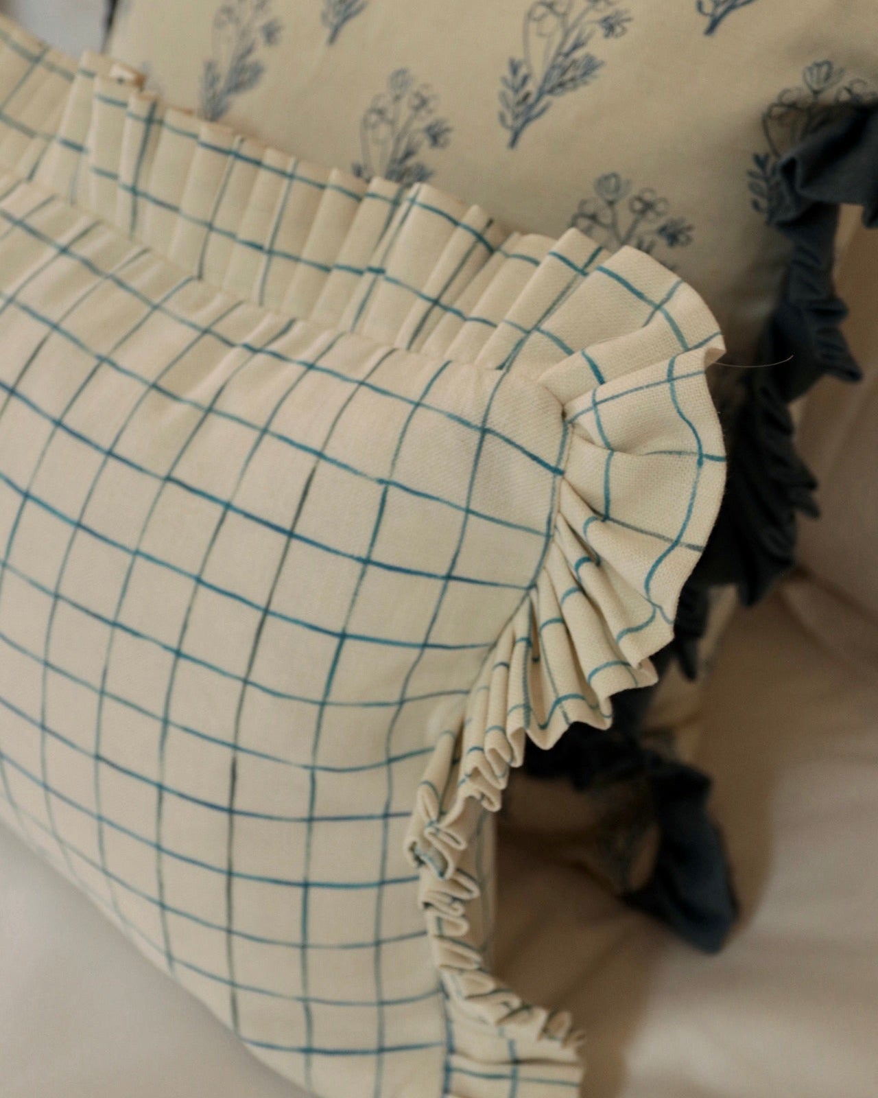 Close-up of a fabric item with a grid pattern on a floral background
